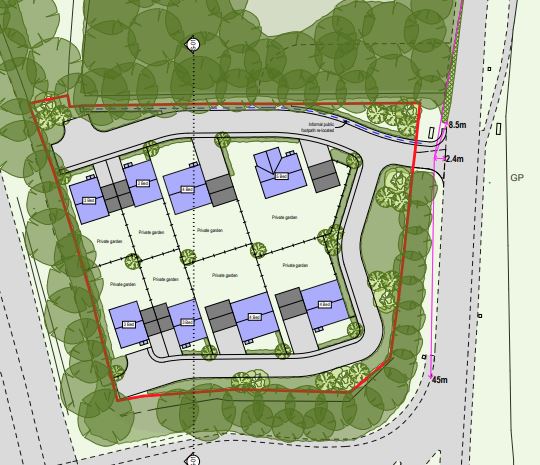 Planning consultant reviewing site drawings on a rural development plot.